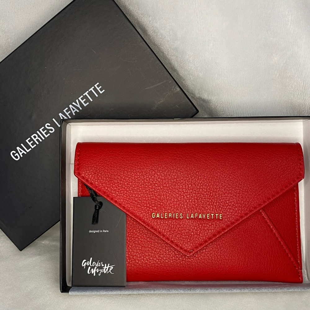 Galleries Lafayette envelope sized faux leather in red. With store tags.